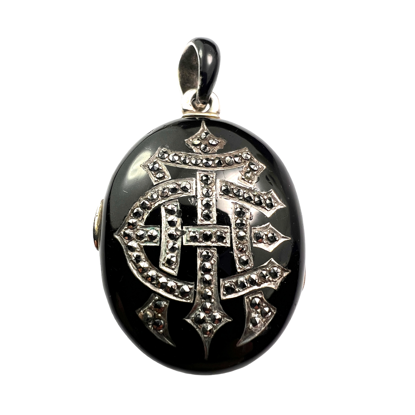 Black pendant with silver intricate design on a white background 